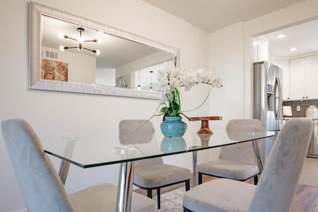 dining space with hardwood / wood-style flooring