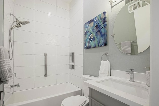 full bathroom with vanity, tiled shower / bath, and toilet