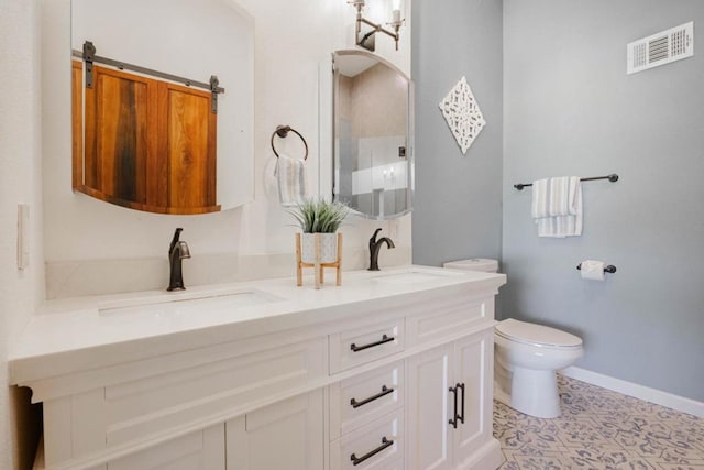 bathroom featuring vanity and toilet