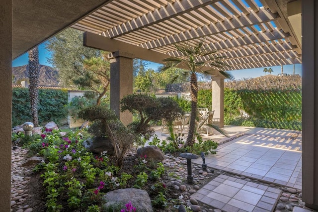 view of patio with a mountain view and a pergola