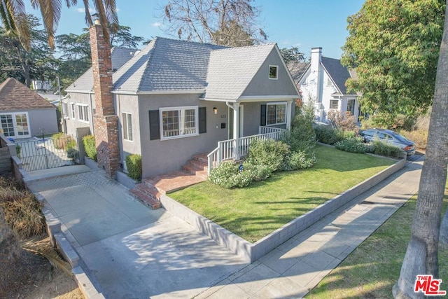 view of front of house featuring a front yard and covered porch