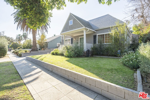 view of front of home featuring a porch and a front yard