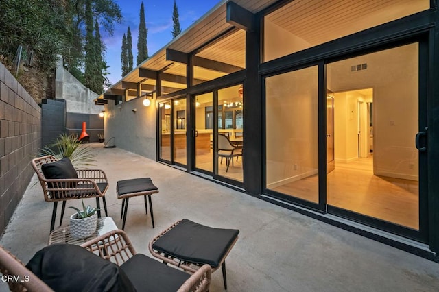 view of patio terrace at dusk