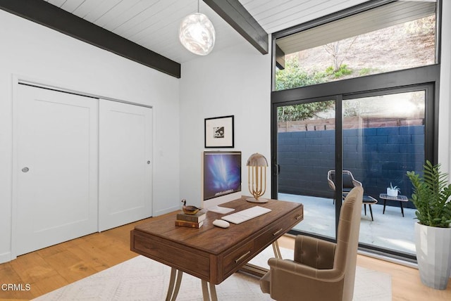 office area featuring beamed ceiling and light hardwood / wood-style flooring