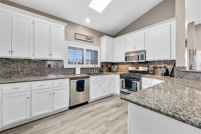 kitchen featuring white cabinetry, stainless steel appliances, and stone countertops