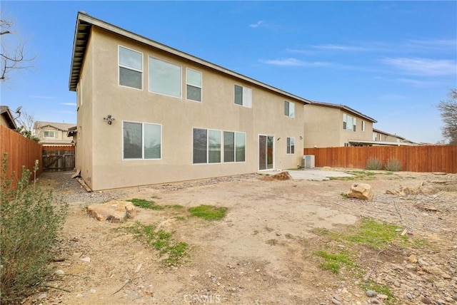 rear view of property with central AC unit