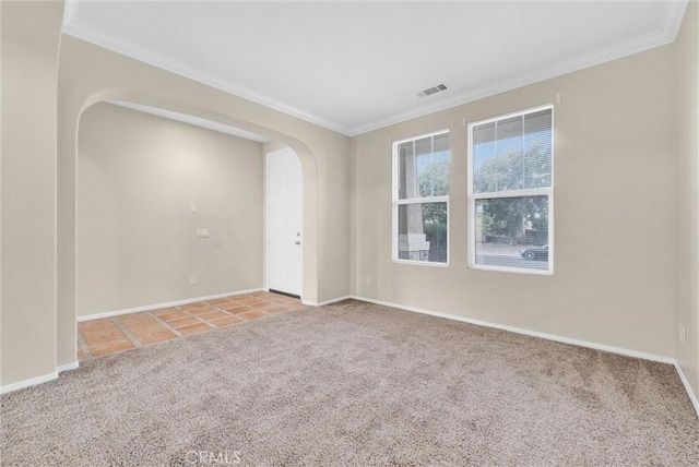 unfurnished room with ornamental molding and light carpet