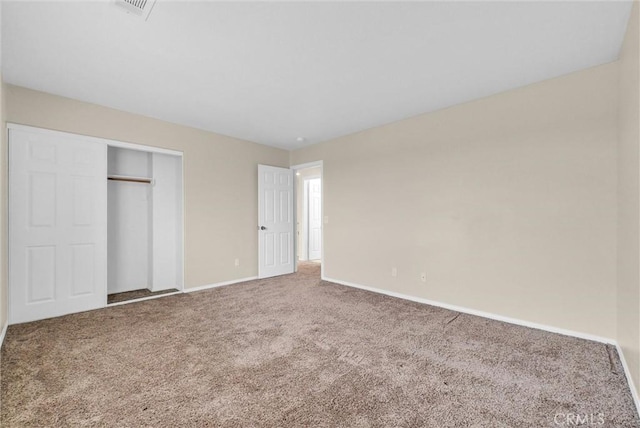 unfurnished bedroom with carpet flooring and a closet