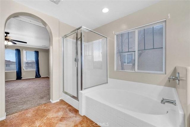 bathroom featuring ceiling fan and separate shower and tub