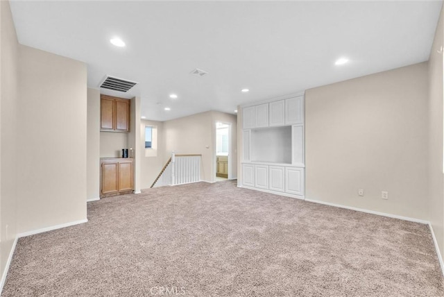 unfurnished living room with light carpet