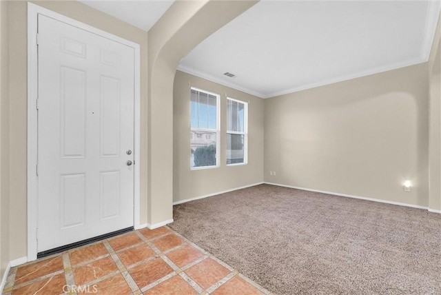 carpeted entryway with ornamental molding