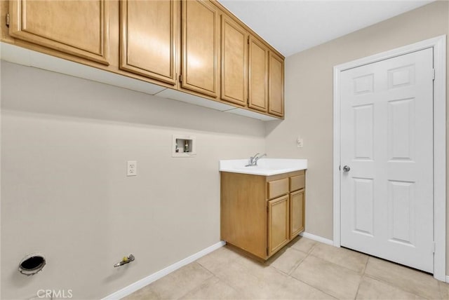 laundry area with gas dryer hookup, light tile patterned floors, sink, hookup for a washing machine, and cabinets