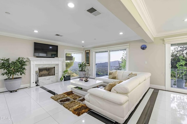 living room featuring crown molding, a healthy amount of sunlight, light tile patterned floors, and a high end fireplace