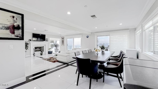 tiled dining area featuring ornamental molding