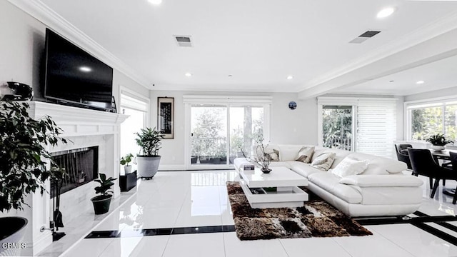 living room with light tile patterned floors, crown molding, and a high end fireplace