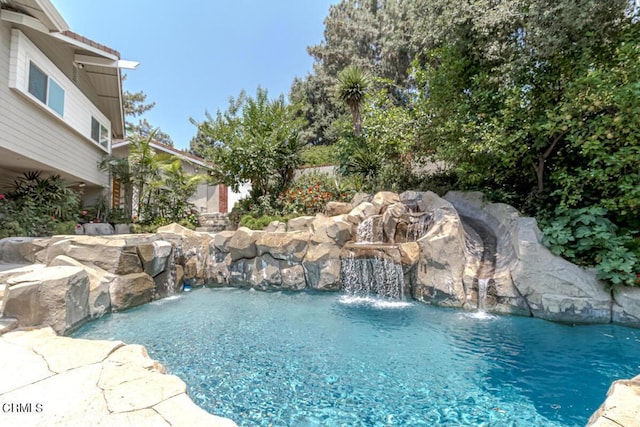 view of swimming pool featuring pool water feature