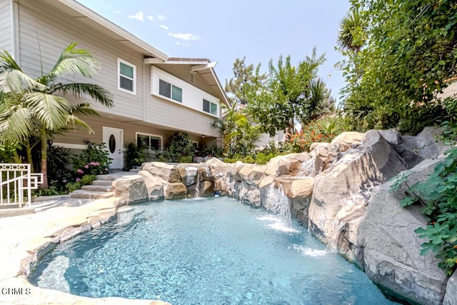 view of swimming pool featuring pool water feature