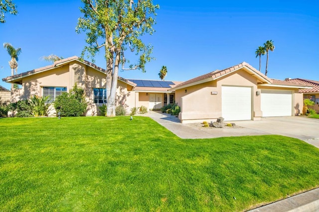 ranch-style house featuring a garage, a front lawn, and solar panels