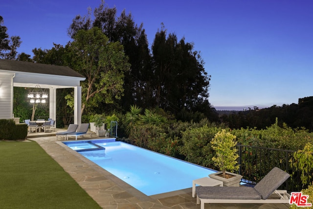 view of swimming pool with a patio and an in ground hot tub