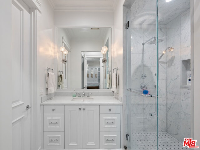 bathroom with crown molding, vanity, and walk in shower