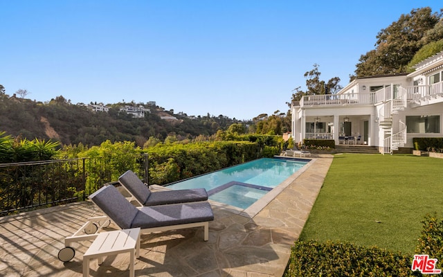 view of pool featuring a lawn, a patio, and an in ground hot tub