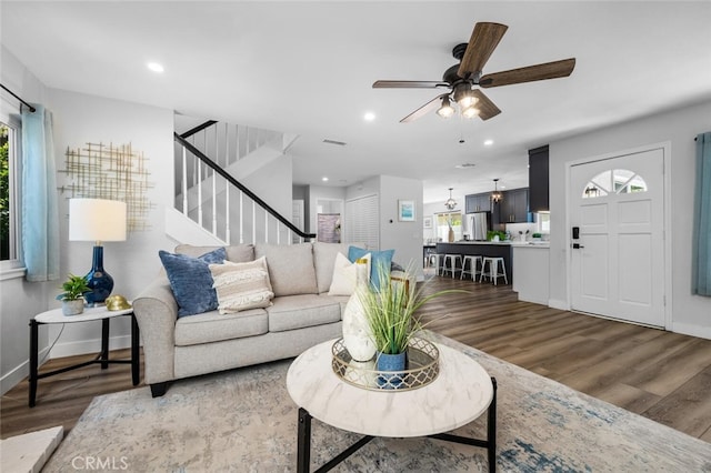 living room featuring dark hardwood / wood-style floors and ceiling fan