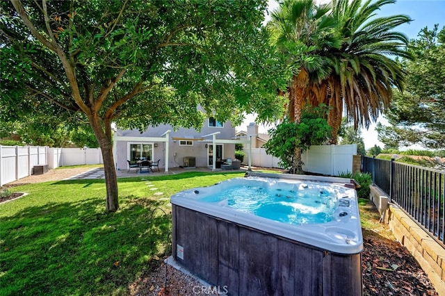 view of pool with central AC, a yard, a hot tub, and a patio