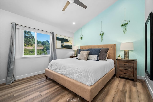 bedroom featuring hardwood / wood-style flooring, ceiling fan, and lofted ceiling