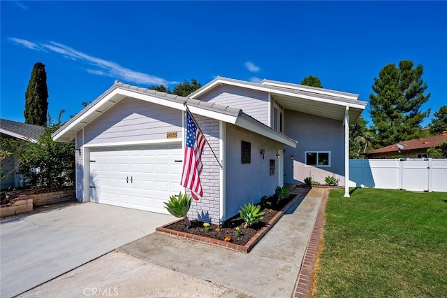 view of front facade with a garage and a front yard