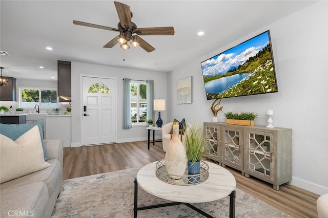 living room featuring ceiling fan and light wood-type flooring