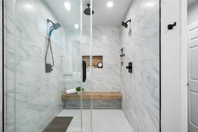 bathroom featuring a shower with shower door