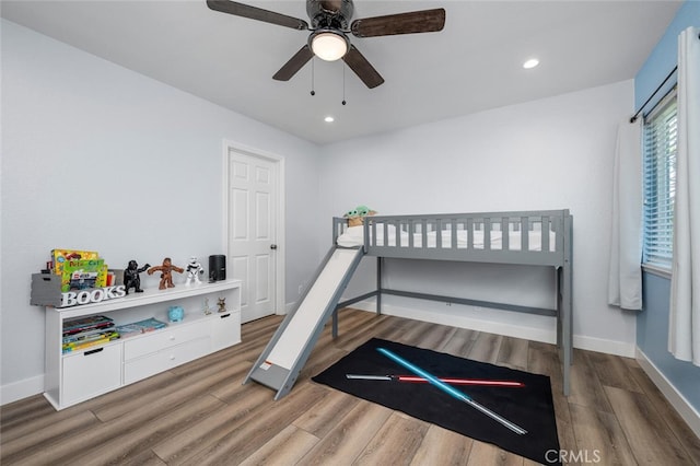 bedroom with ceiling fan and dark hardwood / wood-style flooring