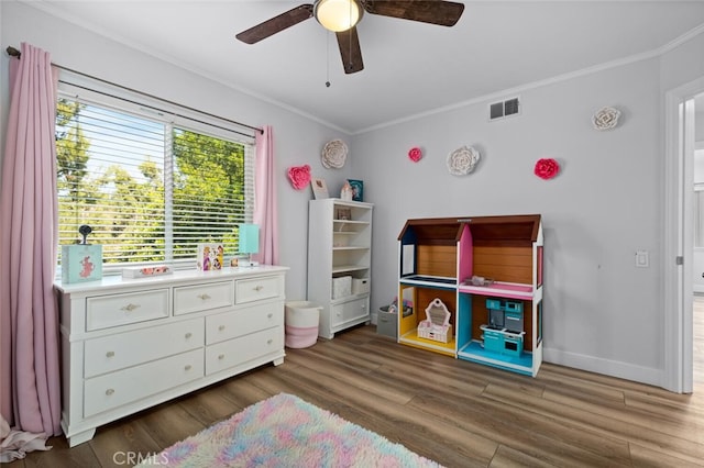 bedroom featuring ceiling fan, ornamental molding, and dark hardwood / wood-style floors