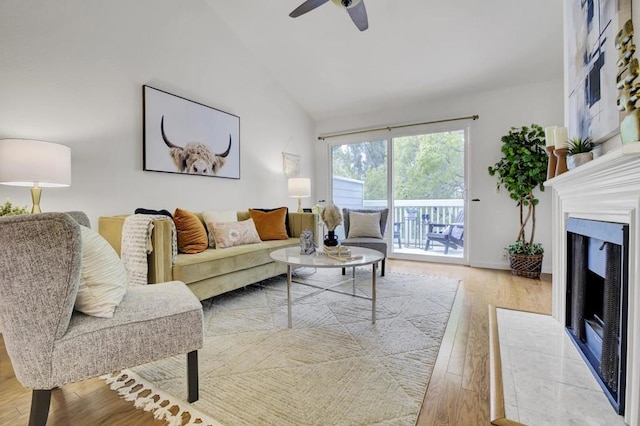 living room featuring ceiling fan, high vaulted ceiling, and light hardwood / wood-style floors