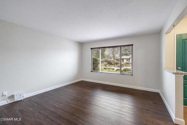 empty room featuring dark hardwood / wood-style flooring