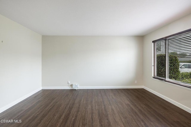 empty room featuring dark hardwood / wood-style flooring