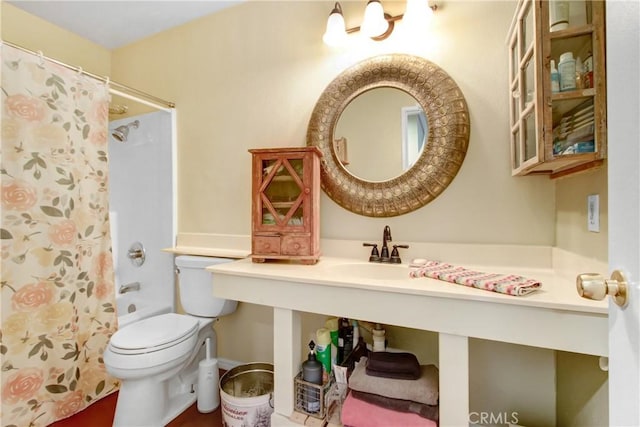 bathroom with sink, curtained shower, and toilet