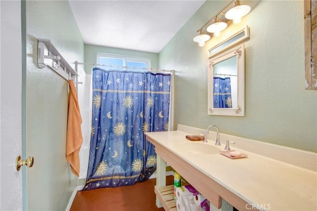 bathroom featuring a shower with shower curtain and sink