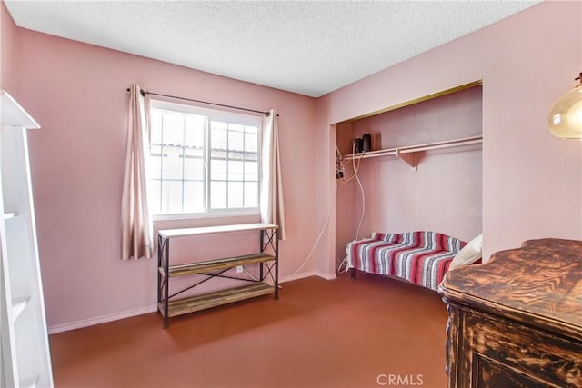 carpeted bedroom with a textured ceiling and a closet