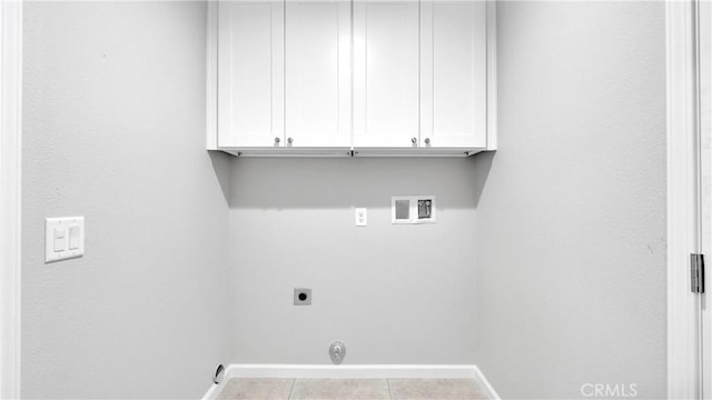 laundry area with light tile patterned flooring, cabinets, hookup for a washing machine, and electric dryer hookup