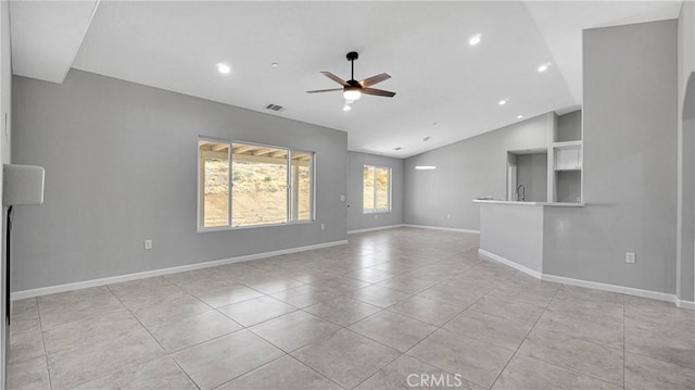 unfurnished living room featuring ceiling fan, vaulted ceiling, and light tile patterned floors