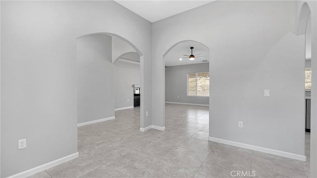 spare room featuring light tile patterned flooring and ceiling fan