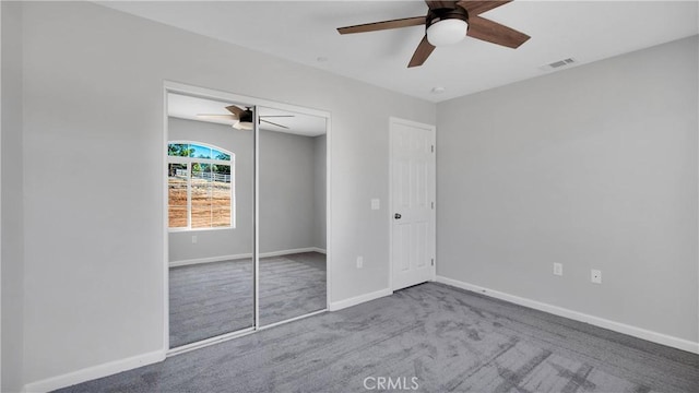 unfurnished bedroom featuring light carpet, a closet, and ceiling fan