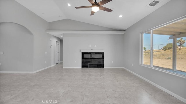 unfurnished living room with ceiling fan, lofted ceiling, and light tile patterned floors