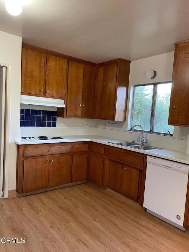 kitchen featuring sink, white appliances, and light hardwood / wood-style floors