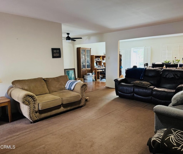 carpeted living room featuring ceiling fan