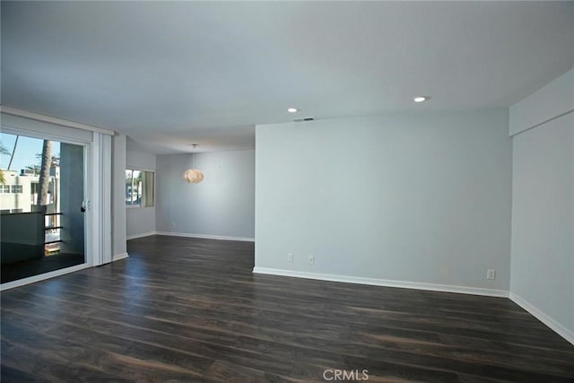 empty room with dark wood-type flooring