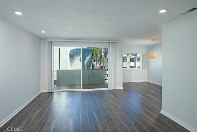 unfurnished room with dark wood-type flooring