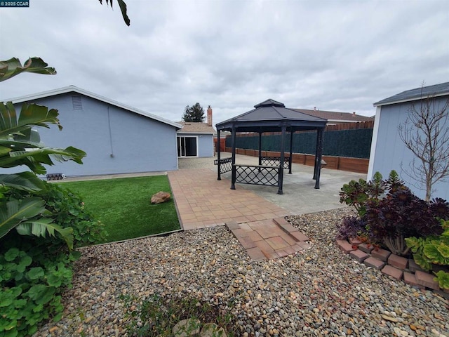 view of yard featuring a gazebo and a patio area