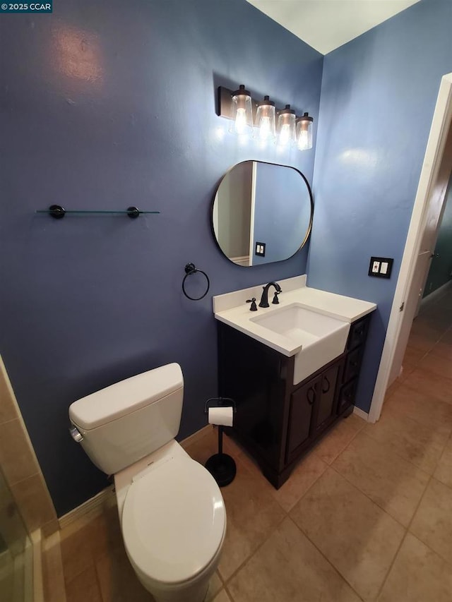 bathroom featuring vanity, toilet, and tile patterned flooring